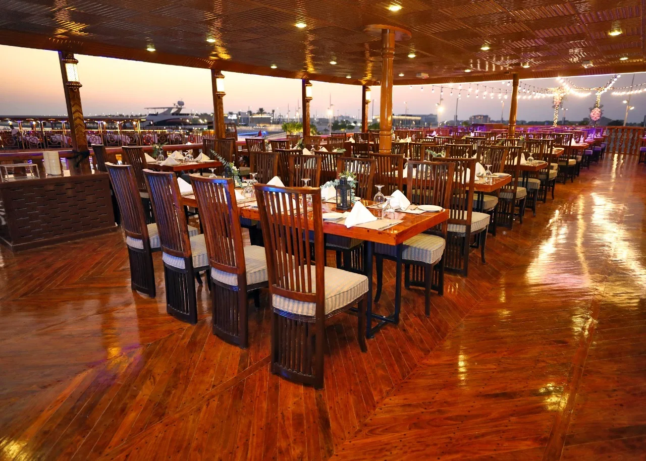 Row of dining tables set for dinner on the dhow