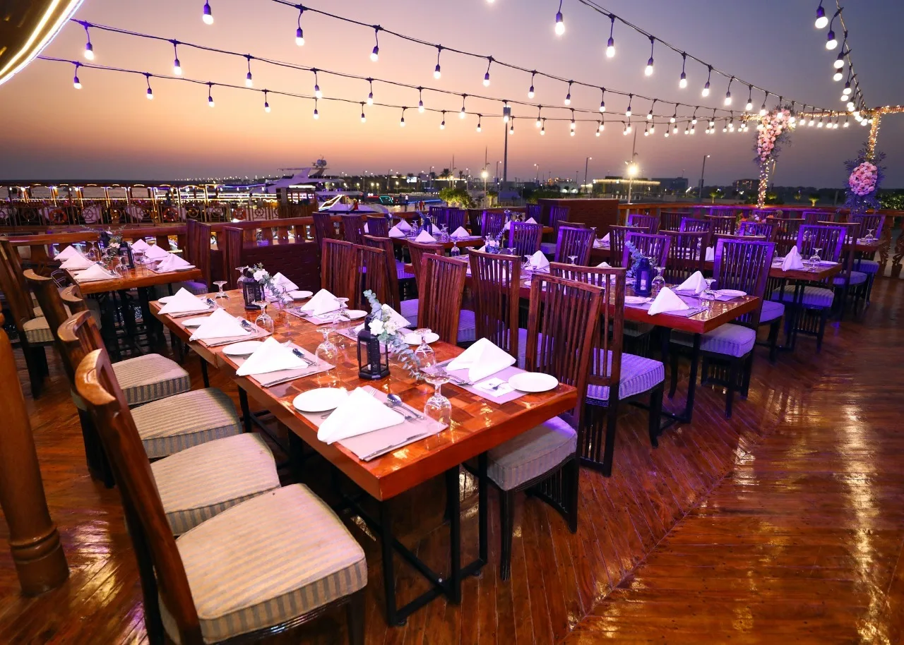 Dining tables set up for a sunset cruise