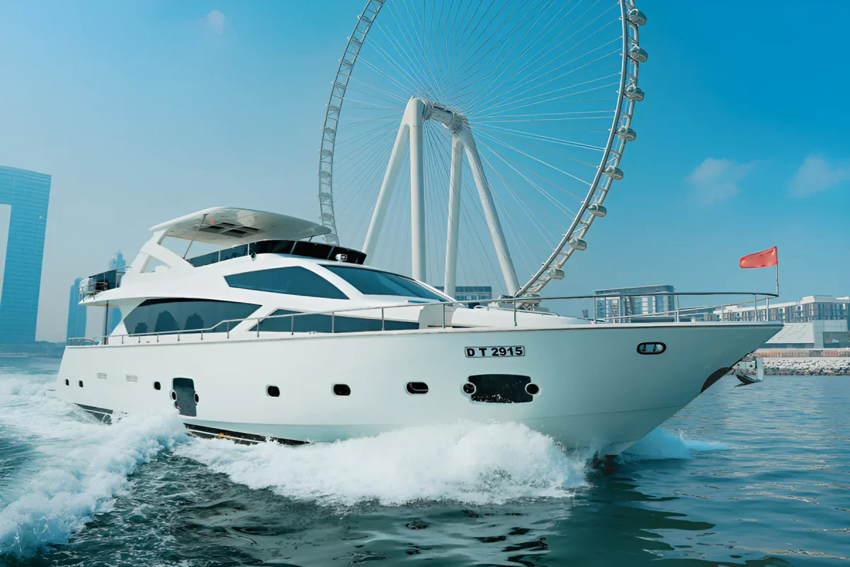 Yacht bow approaching the Ain Dubai wheel on calm water under a clear blue sky